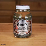 Odie's Safer Solvent 32 oz jar on wooden table, food grade citrus wood finish solvent