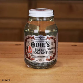 Odie's Safer Solvent 32 oz jar on wooden table, food grade citrus wood finish solvent