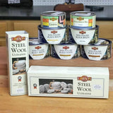 Liberon steel wool and wax polish tins for woodworking on a workshop table