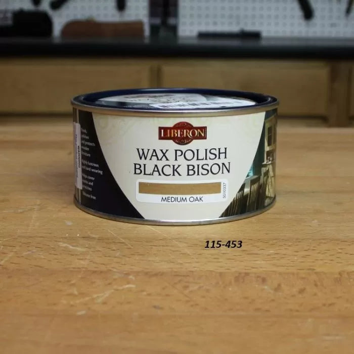 Liberon Wax Polish Black Bison Medium Oak can for woodworking on a workbench