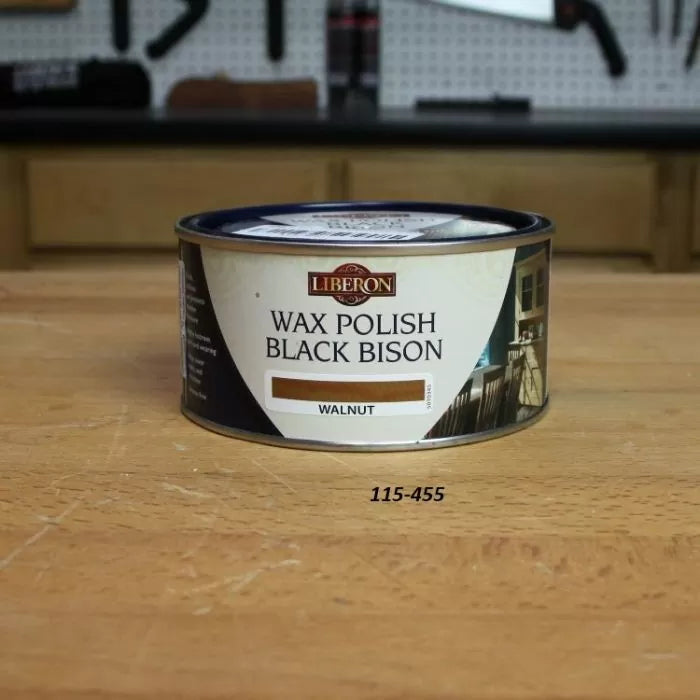 Liberon Black Bison Wax Polish Walnut tin on a wooden workbench in a workshop