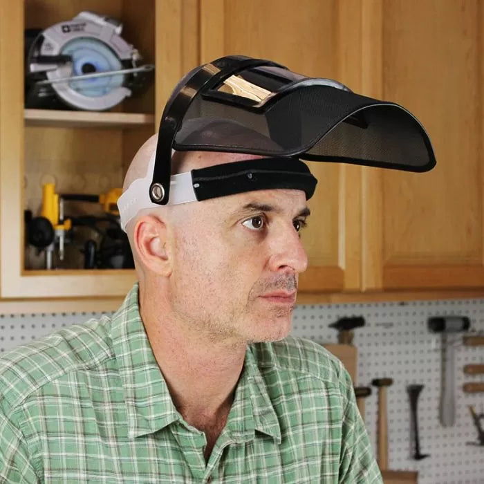 Man wearing woodworking safety face shield visor in workshop setting