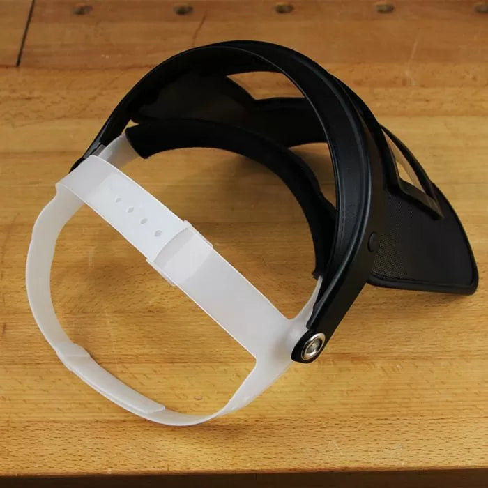 Woodworking face shield with adjustable headband on a workshop table
