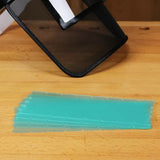 Pack of dovetail alignment boards and a mesh face shield on a woodworking bench