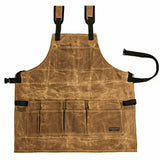 Brown waxed canvas woodworking apron with multiple front tool pockets and adjustable straps
