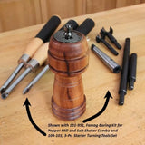 Wood pepper mill with starter woodturning tools and boring kit on a workbench