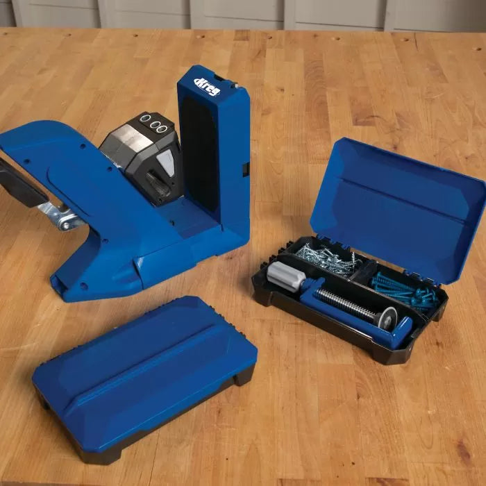 Pocket hole jig woodworking tool with opened storage case and hardware on workbench