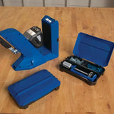 Pocket hole jig woodworking tool with opened storage case and hardware on workbench
