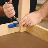 Woodworker using pocket hole clamp and jig to join two pieces of wood at a right angle