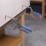 Woodworking face clamps with blue handles securing a board to a workbench