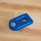 Blue woodworking jig accessory with hex bolt on light wood surface