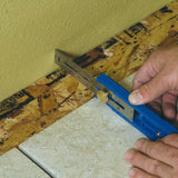 Woodworker using a marking gauge tool to measure against a wall and wood surface