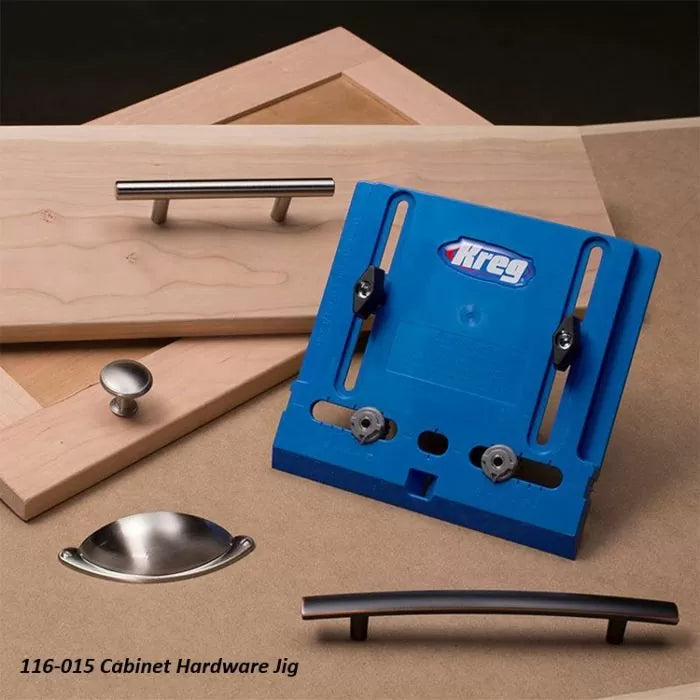 Cabinet hardware jig with blue template and various drawer and door handles on wood panels.
