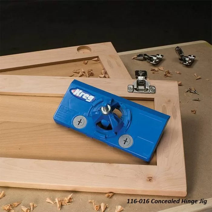 Blue concealed hinge jig tool on wooden cabinet doors with installed hinges, woodworking setting