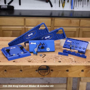 Kreg cabinet maker and installer kit with blue woodworking jigs on a workbench in a workshop