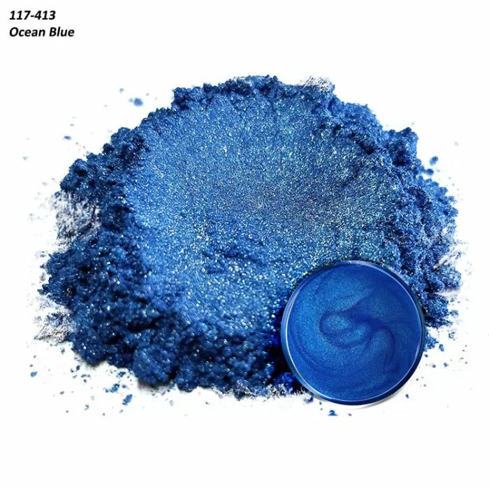 Ocean blue metallic mica powder for woodworking resin, shown loose and mixed in a small dish