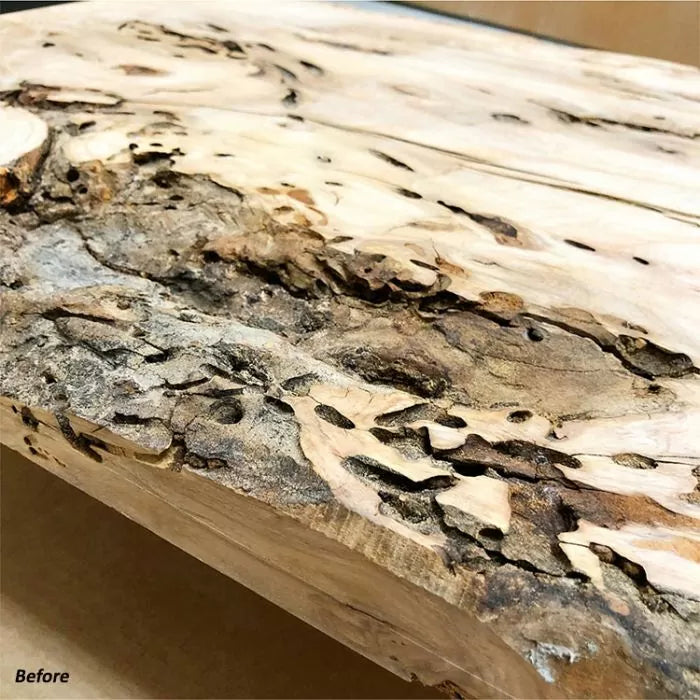 Close-up of rough, unfinished live edge wood slab with bark and natural texture