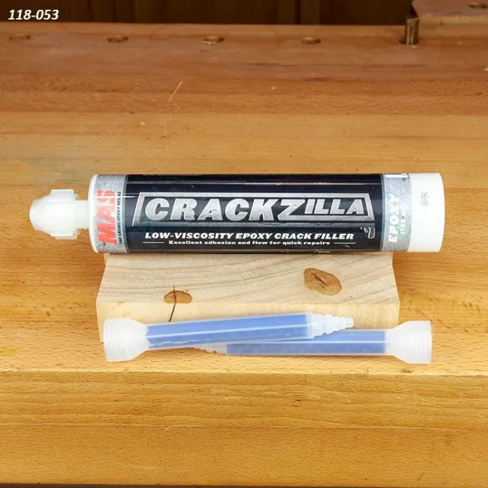 CrackZilla low-viscosity epoxy crack filler tube on wood surface with nozzles for woodworking repairs