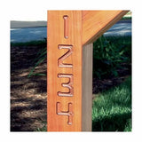 Close-up of wooden post with routed carved numbers 1 2 3 4 outdoors, woodworking detail