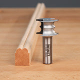 beading router bit with cut wood profile on woodworking bench