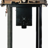Underside view of a router table with metal legs and integrated dust collection port