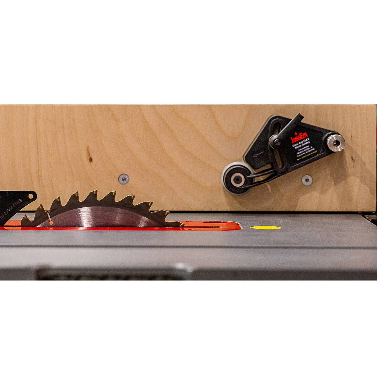 Table saw blade with safety guide and wooden fence for precision woodworking cuts