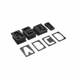 Set of black router guide bushings and templates for woodworking projects, arranged on white background.