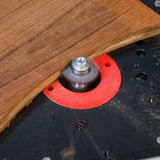 Woodworking router table with spinning router bit cutting curved wood edge