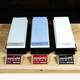 Three CERAX sharpening stones in different grits on wooden surface for woodworking tools