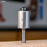 Carbide flush trim router bit with bearing for woodworking, displayed on a workbench