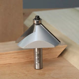 Carbide-tipped chamfer router bit for woodworking on a wooden surface