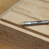 Carbide woodworking router bit on a wooden surface for precision joinery cuts