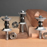Woodworking router bits and bearings displayed with decorative wood molding pieces.