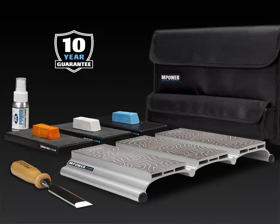 Woodworking chisel sharpening kit with honing guide, abrasive blocks, lapping fluid, and storage case