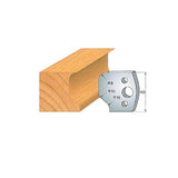 Woodworking molding profile cutter next to shaped wood block with radius markings and measurements
