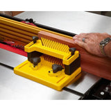 Table saw featherboard guide holding wood, woodworking tool for precision cutting