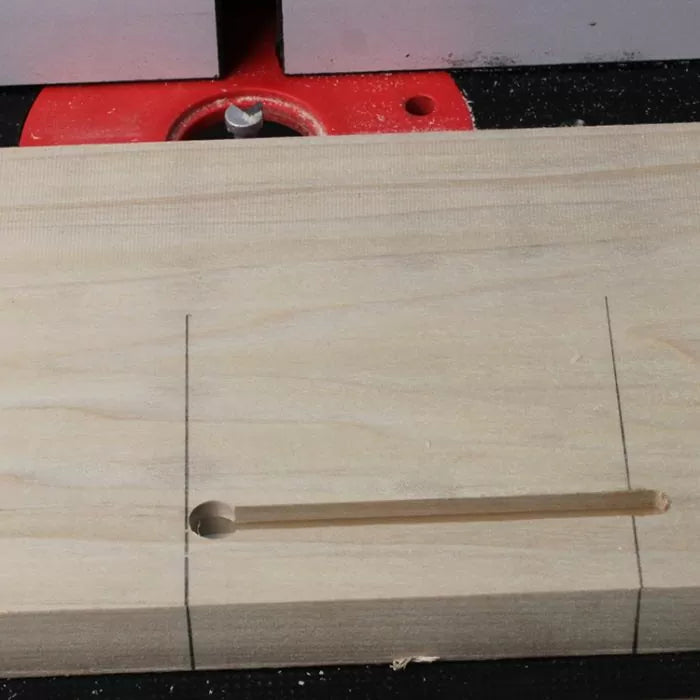 Wooden board with a routed slot and end hole, precision woodworking joinery setup