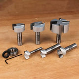 Woodworking router bits set with bearings and hex key on wood surface