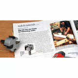 Large router bit and magazine review on woodworking slab flattening, shown on a desk