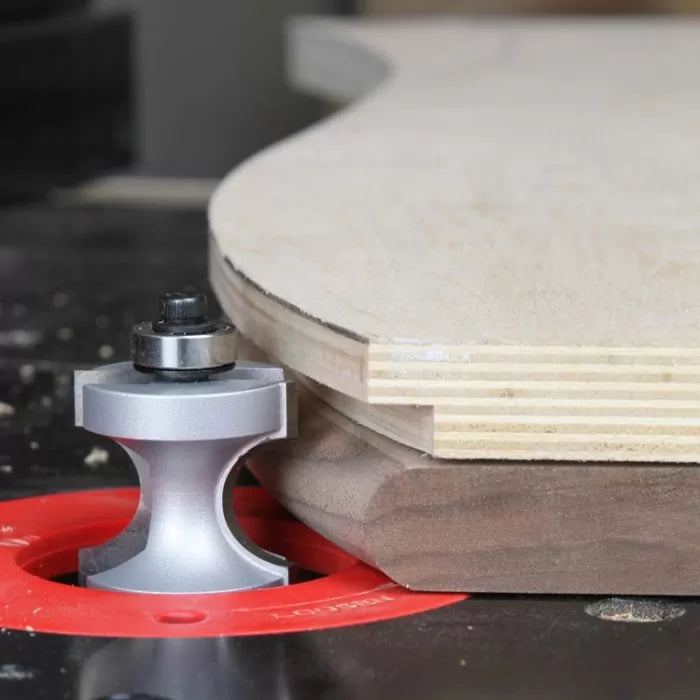 Roundover router bit trimming plywood edge on router table for woodworking