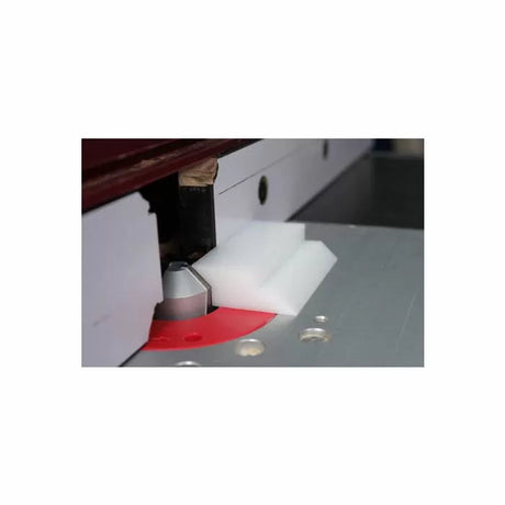 Router table setup with router bit and white push block for woodworking precision