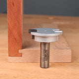 Woodworking slot cutter router bit beside wood joint on workbench