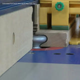 Router table cutting hardwood with a roundover bit and push block for woodworking precision