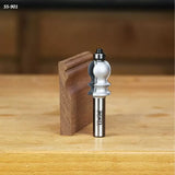 Woodworking router bit with ball-bearing guide and decorative edge sample on a workbench