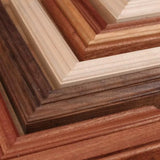 Assorted wooden picture frame corners in various finishes, showcasing detailed woodworking.