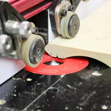 Woodworking router table with router bit cutting decorative edge on wood board.