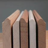 Close-up of five wood molding profiles with rounded edges for woodworking projects