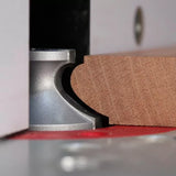 Wood router bit shaping hardwood edge on router table for detailed woodworking
