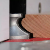 Roman ogee router bit shaping wooden edge on a router table