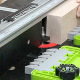 Woodworking router table setup with fence, jig, and block of wood for precise joinery